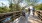 a family riding their bicycles across a wooden park bridge